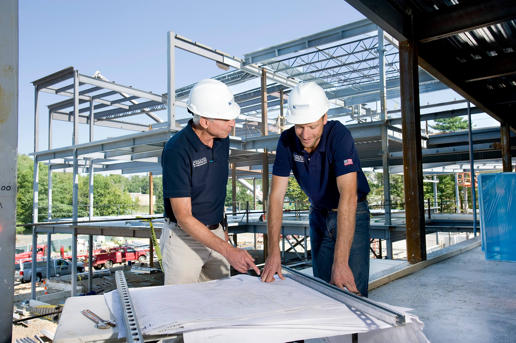 two people looking at plans at a construction site