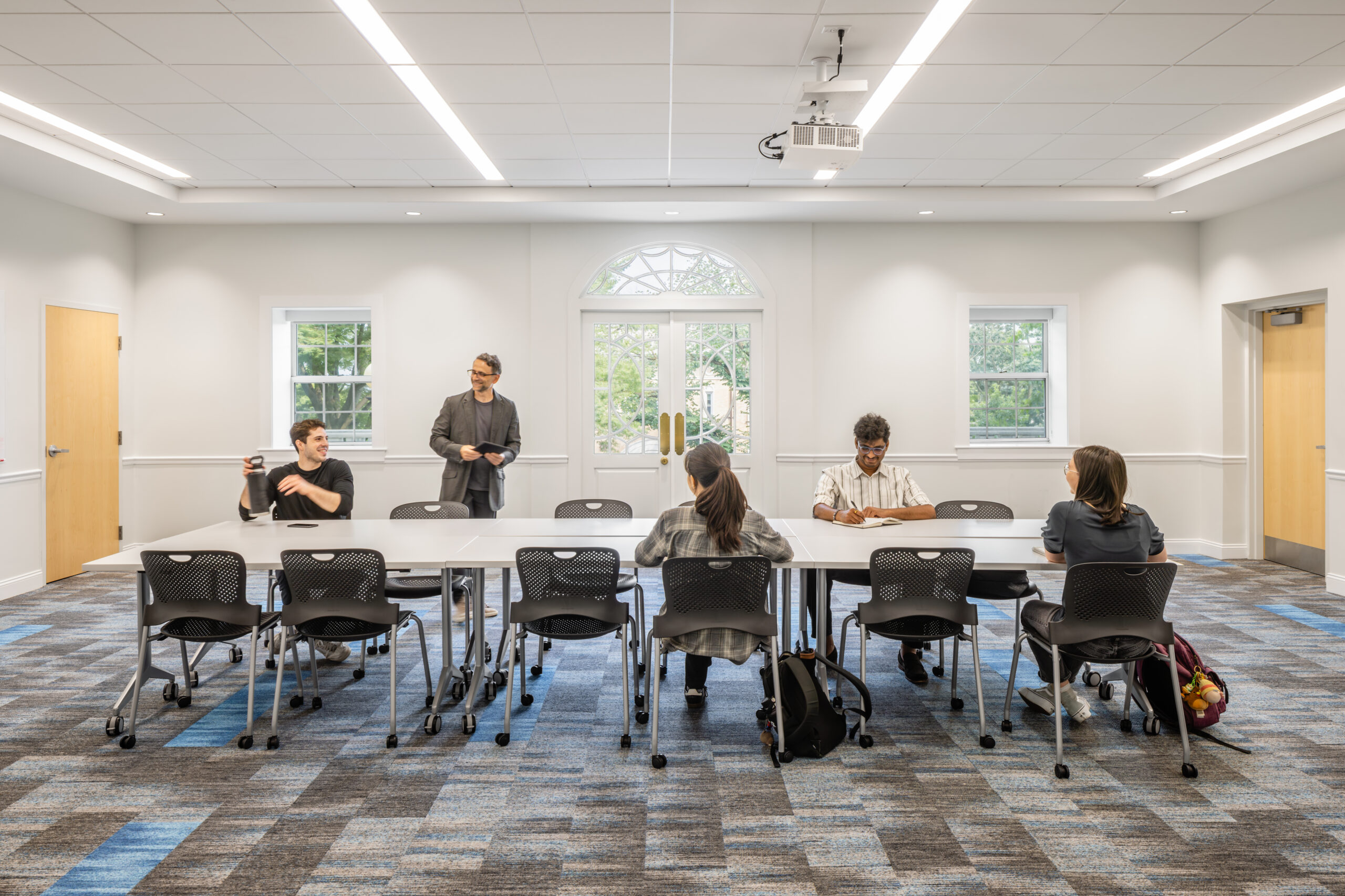 Tufts Eaton Hall Classroom with a long table and chairs set up in the center